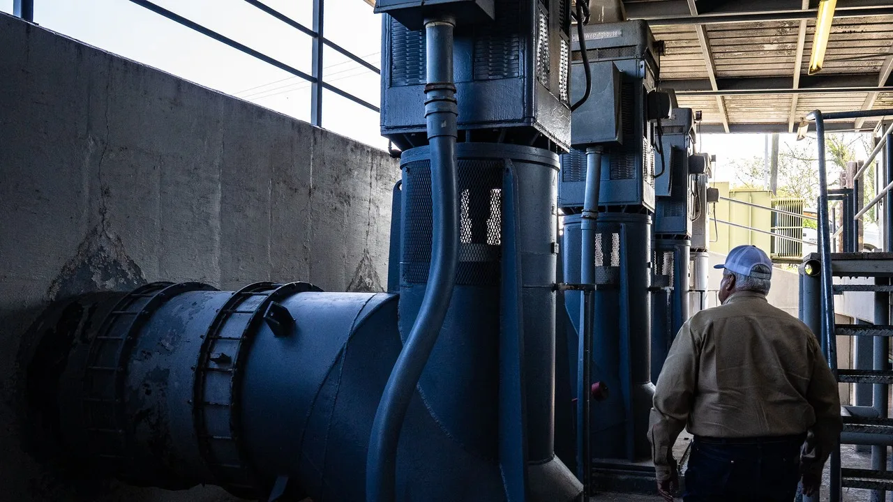 Large blue pumps and a discharge pipe at the Hidalgo County Irrigation District No. 2 pump station on the Rio Grande at McAllen