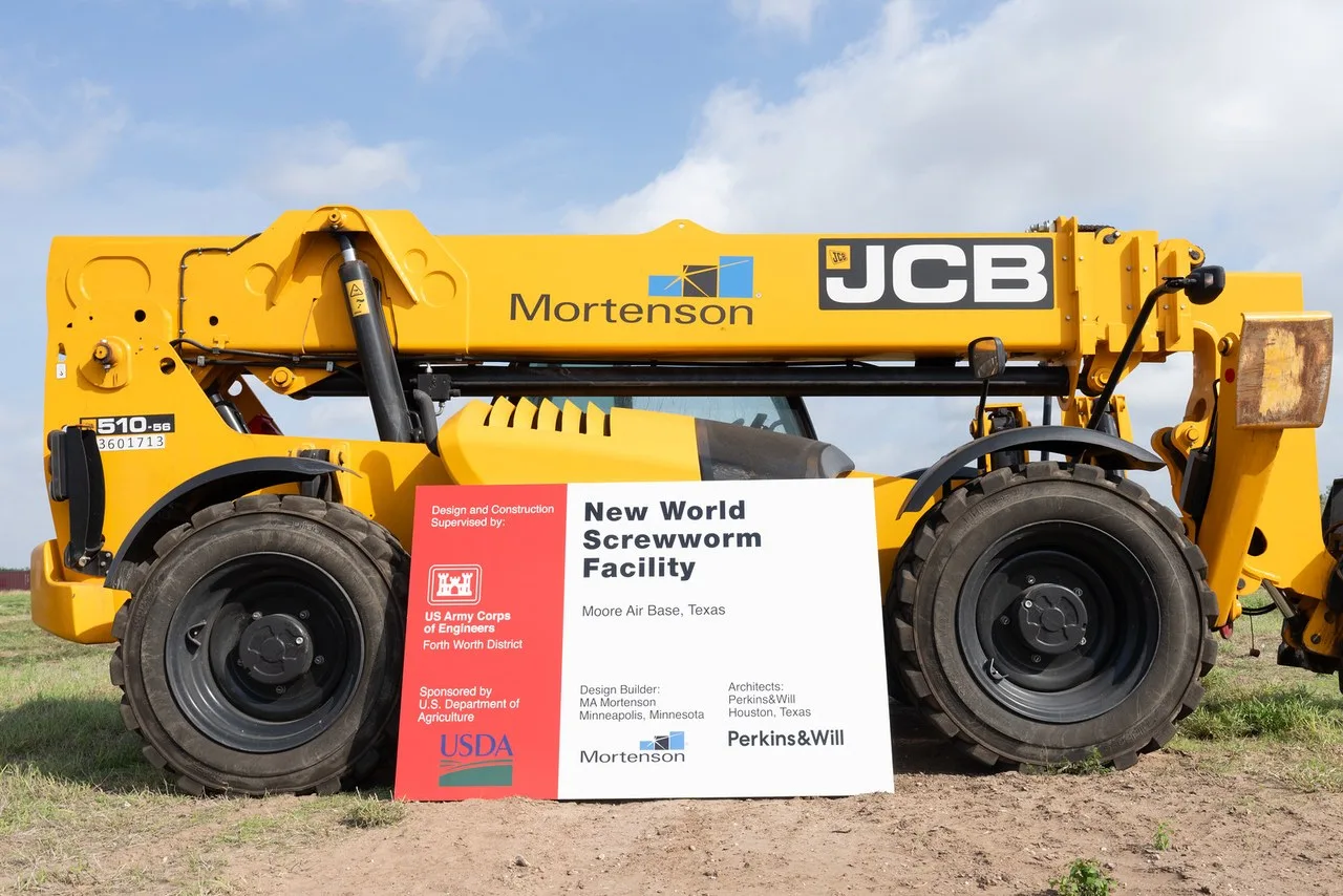 A yellow JCB 510-56 telehandler parked behind a project sign on a construction site at Moore Air Base in Edinburg, Texas