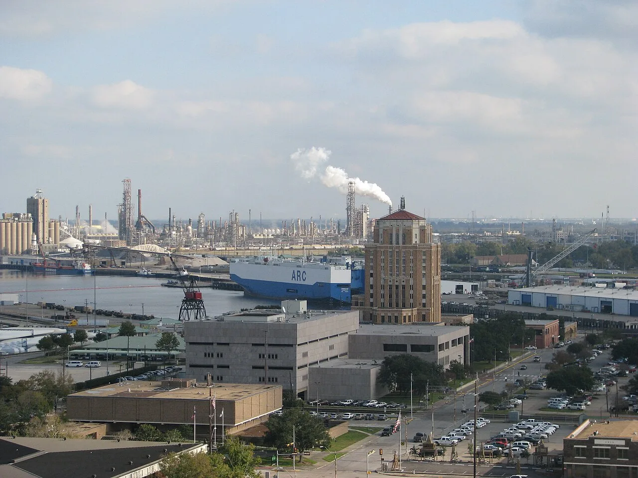 Downtown Beaumont with the Port of Beaumont on the Neches River, a ship at berth and refineries on the horizon