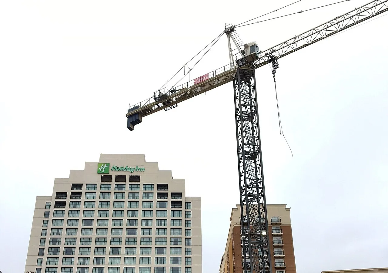A tower crane at work beside the Holiday Inn among the River Walk hotels in downtown San Antonio