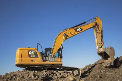 Caterpillar 330 excavator operating on a job site in the Texas Triangle, representing 'Yellow Iron' construction fleets that require SBA 504 on-site inspections and heavy equipment appraisal in Dallas, Ft. Worth, and Austin.